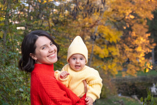 Portrait Mother and Baby Smiling in Autumn Park