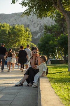 Family sitting on bench in Croatia park