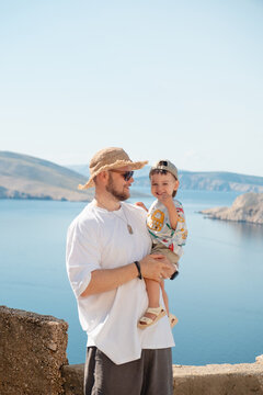 Father holding toddler at Croatia sea viewpoint