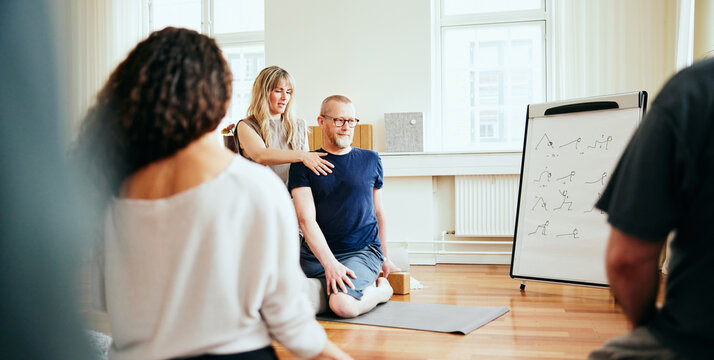 Yoga teacher demonstrating the seated twist pose