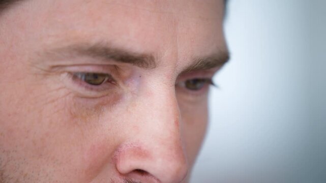 Extreme close up male eyes looking away unrecognizable Caucasian businessman concentrated focused look business man wrinkled face cropped view eyesight health medicine laser correction medication
