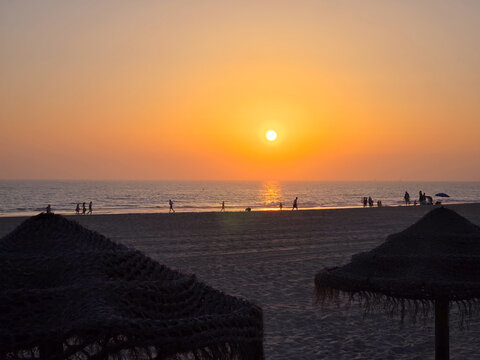 sunset on La Barrosa beach in Sancti Petri, Cadiz, Spain
