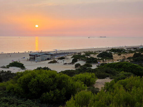 sunset on La Barrosa beach in Sancti Petri, Cadiz, Spain