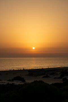 sunset on La Barrosa beach in Sancti Petri, Cadiz, Spain