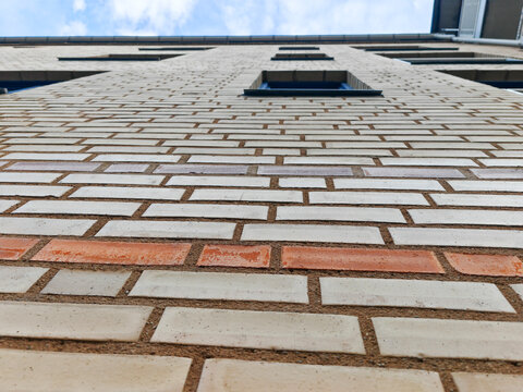 brick facade on the exterior wall of a modern building, viewed from a sharp perspective