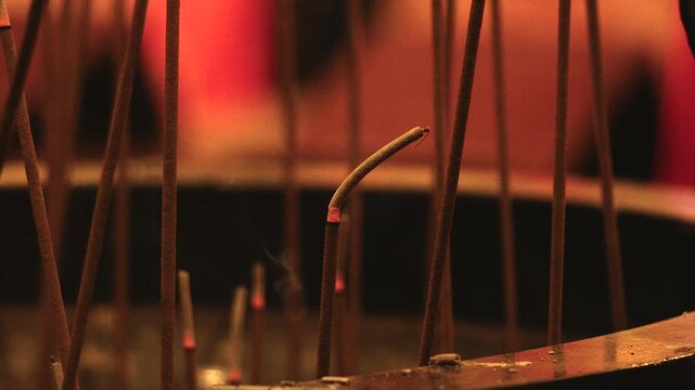Incense Ash Falling from Smoldering Sticks in Quiet Temple Censer