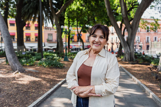 portrait of senior latin woman in public park outdoors in Mexico Latin America, mexican female smiling