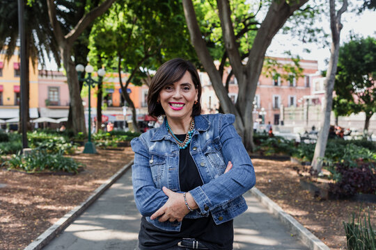 portrait of adult latina woman in public park outdoors in Mexico Latin America, mexican female smiling