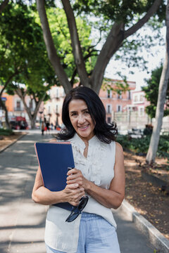 portrait of senior latin woman in public park outdoors in Mexico Latin America, mexican female smiling