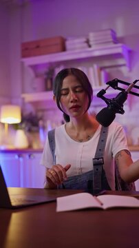 Asian influencer talking in broadcast on social media live on Laptop and smartphone recording online,greeting listeners with coaching life,Stratagem or business at modern home studio.broadcast concept