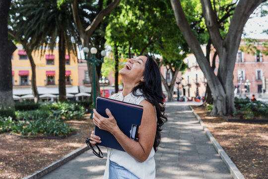 portrait of senior latin woman in public park outdoors in Mexico Latin America, mexican female smiling