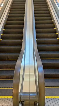 Empty Escalator staircases moving inside office mall building, Elevation Automatic Transport, Travel Infrastructure, Modern Stairway Machine, Eye-Level Shot