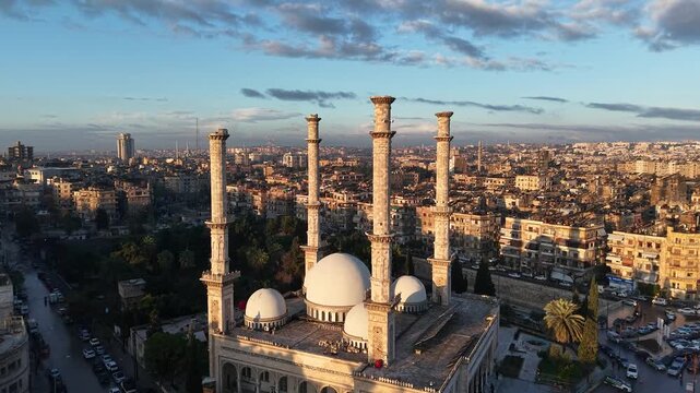 Scenic aerial drone view of an Islamic mosque at sunrise. Urban landscape during the holy month of Ramadan and Eid
