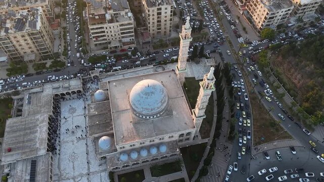 Scenic aerial drone view of an Islamic mosque at sunrise. Urban landscape during the holy month of Ramadan and Eid
