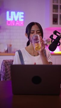 Asian influencer talking in broadcast on social media live on Laptop and smartphone recording online,greeting listeners with coaching life,Stratagem or business at modern home studio.broadcast concept