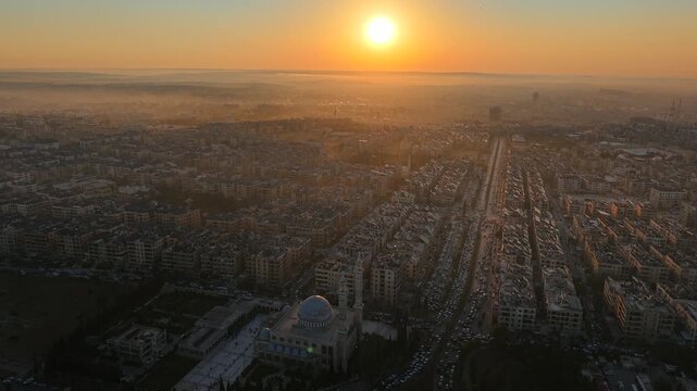 Scenic aerial drone view of an Islamic mosque at sunrise. Urban landscape during the holy month of Ramadan and Eid