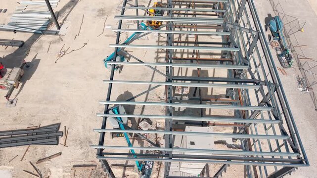 Construction process of steel structure in an outdoor area with workers and equipment in action