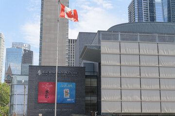 Fototapeta premium flag of Canada and view of Four Seasons Centre for the Performing Arts located at 145 Queen St W, Toronto