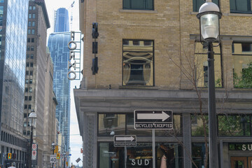 Fototapeta premium one way (bicycles excepted) traffic sign and defocused view, exterior historic building and signage at Sud Forno, a restaurant, located at 132 Yonge St, Toronto