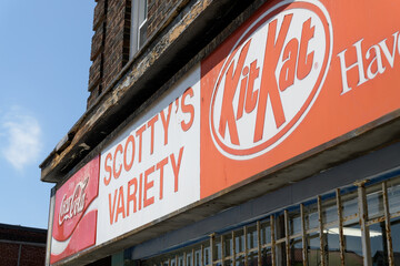 Fototapeta premium exterior building facade and vintage sign of Scotty's Variety Store, a convenience store, located at 1580 Bloor St W, Toronto