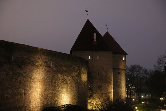 night view of illuminated Tallinn town wall and defensive towers at night