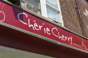 Fototapeta premium exterior building facade and sign at Cherie Cherry, a cafe, located at 1572 Bloor St W, Toronto