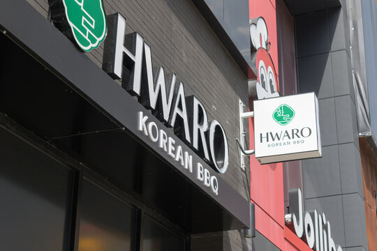 Hwaro Korean BBQ (332 Yonge St) and Jollibee chicken restaurant (334 Yonge St) signs in Toronto
