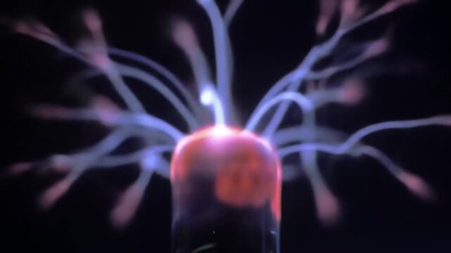 Plasma Ball Glowing with Electric Arcs in a Dark Room Environment