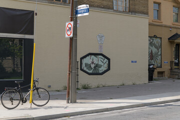 Fototapeta premium historic brick building at 1566–1568 Yonge St - Heath St W, with bicycle in Toronto (site of planned Yonge/Heath intersection realignment)