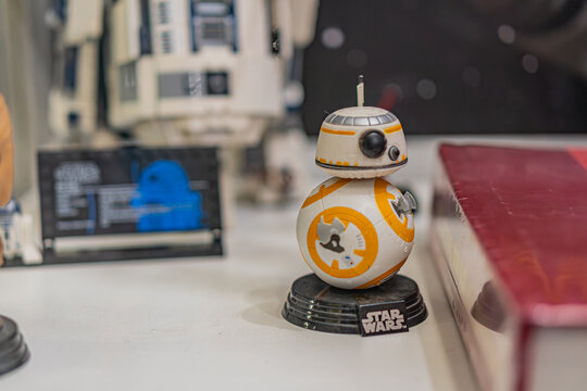 A collection of Star Wars memorabilia, featuring an upright R2-D2 figurine in white and blue, standing before a partially obscured X-wing model C-3PO figurine is - Kyiv, Ukraine - September 27, 2025