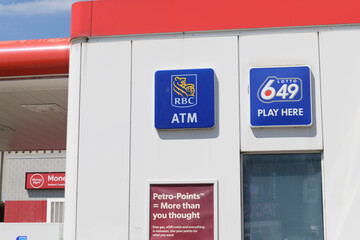 Fototapeta premium RBC ATM and Loto 649 signs outside a gas station convenience store at Petro-Canada, 1750 Bloor St W, Toronto