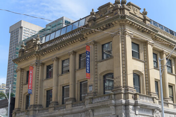 Fototapeta premium exterior building facades and banners of McDonald's Canada fast food restaurant located at 675 Yonge St, Toronto (Postal Station F, designed by SG Curry, 1905)