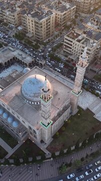 Scenic aerial drone view of an Islamic mosque at sunrise. Urban landscape during the holy month of Ramadan and Eid