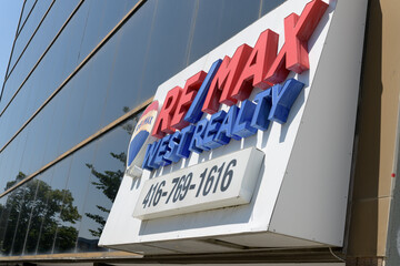 Fototapeta premium sign over entrance to Re/Max West Realty Inc, a real estate agency, located here at 1678 Bloor St W (inside The High Park Real Estate Group), Toronto