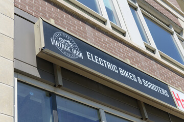 Fototapeta premium shop sign outside Vintage Iron Cycles - Electric Bikes & Electric Scooters located at 1644 Bloor St W (inside The Address), Toronto