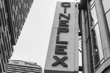 Fototapeta premium black and white upward view of projecting sign outside Cineplex Cinemas, a movie theatre complex, located at 2300 Yonge St (Yonge Eglinton Centre), Toronto