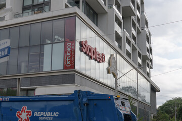 Fototapeta premium garbage truck zooms by Staples, an office supply store, located at 2149 Yonge St, Toronto