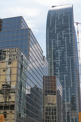 Fototapeta premium perspectival view of Berczy Square (33 Yonge St) and L-Tower, Daniel Libeskind's sculptural residential tower at 8 The Esplanade, Toronto