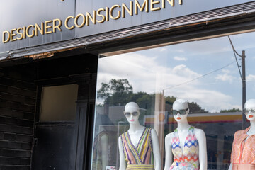 Fototapeta premium mannequins with sunglasses red lip stick and summer dresses inside shop window at 1132 Consignment, 1132 Yonge St, Toronto