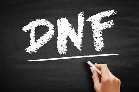 DNF Did Not Finish acronym written on chalkboard. Used in sports, racing, and reading to indicate that a participant or reader did not complete the activity or book before the end