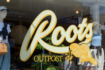 Fototapeta premium window sign at Roots Rosedale - Outpost, a clothing store, located at 1096A Yonge St, Toronto