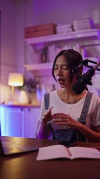 Asian influencer talking in broadcast on social media live on Laptop and smartphone recording online,greeting listeners with coaching life,Stratagem or business at modern home studio.broadcast concept