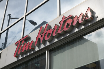 Fototapeta premium exterior building facade and sign of Tim Hortons, a coffee shop chain, located here at 1910 Yonge St inside Davisville Centre, Toronto