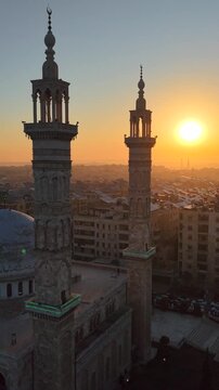 Scenic aerial drone view of an Islamic mosque at sunrise. Urban landscape during the holy month of Ramadan and Eid