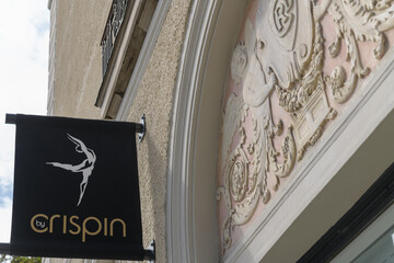 Fototapeta premium projecting sign of By Crispin, a gym, located outside a historic building at 1044 Yonge St, Toronto