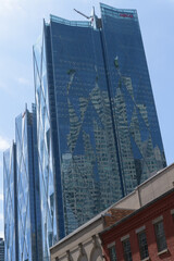 Fototapeta premium reflection of Brookfield Place on the diamond patterned windows of CIBC Square, designed by WilkinsonEyre, located at 81 and 141 Bay St, Toronto (headquarters of Canadian Imperial Bank of Commerce, an