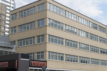 Fototapeta premium mid century modern building and sign of Chipotle Mexican Grill, a Mexican restaurant chain, located at 1407 Yonge St, Toronto (St Clair)