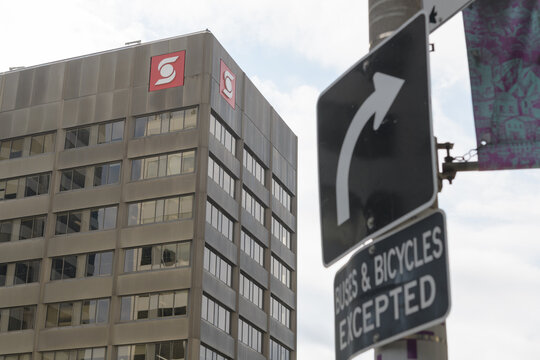 corporate logo sign of the Bank of Nova Scotia on a business tower at 1 St Clair Av E southeast corner of Yonge St, Toronto (with traffic sign)