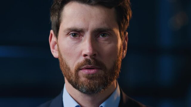Portrait serious Caucasian mature business man looking at camera at dark office calm confident middle-aged 40s businessman male startup owner founder boss employer executive at evening night agency