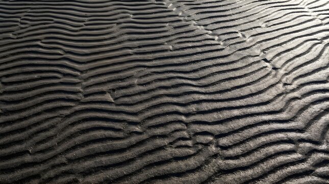 Rippled sand texture on beach forming natural abstract patterns at sunset